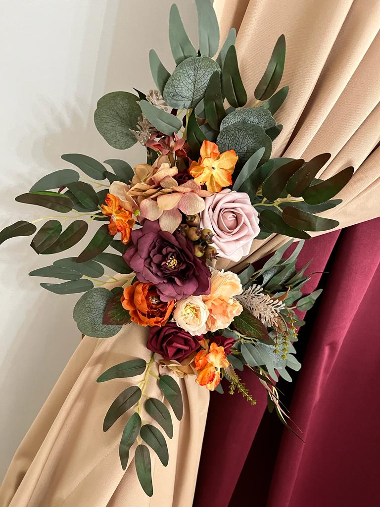 A bouquet of flowers on the corner of a window.