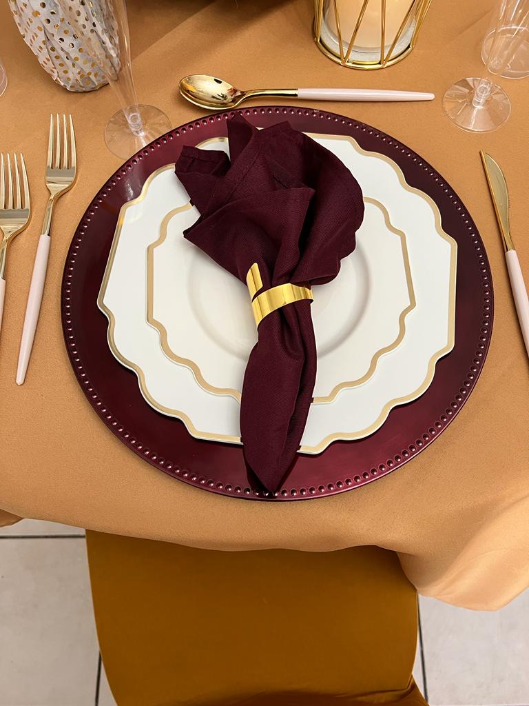 A table set with plates, silverware and napkins.