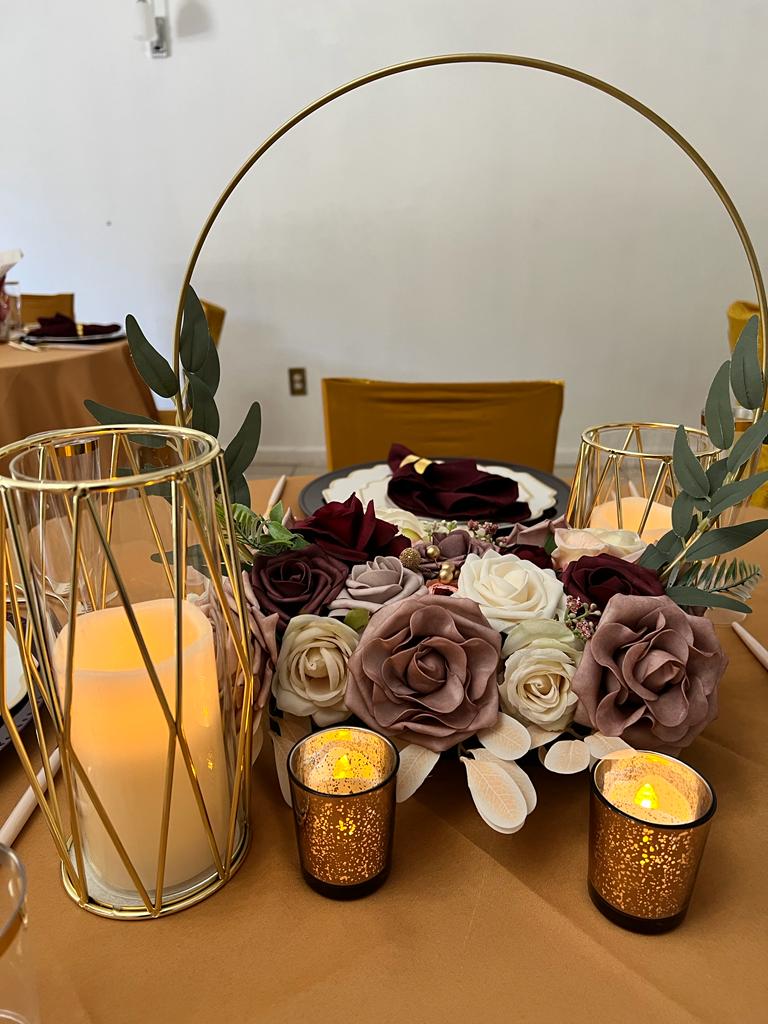 A table with candles and flowers on it