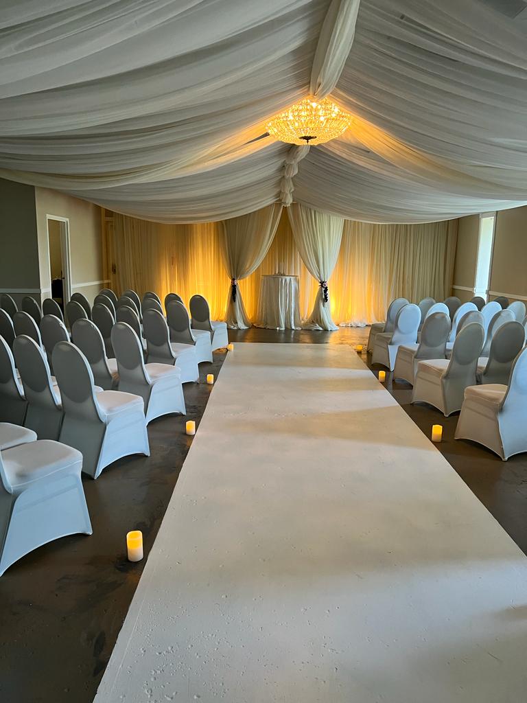 A large white tent with many chairs in it