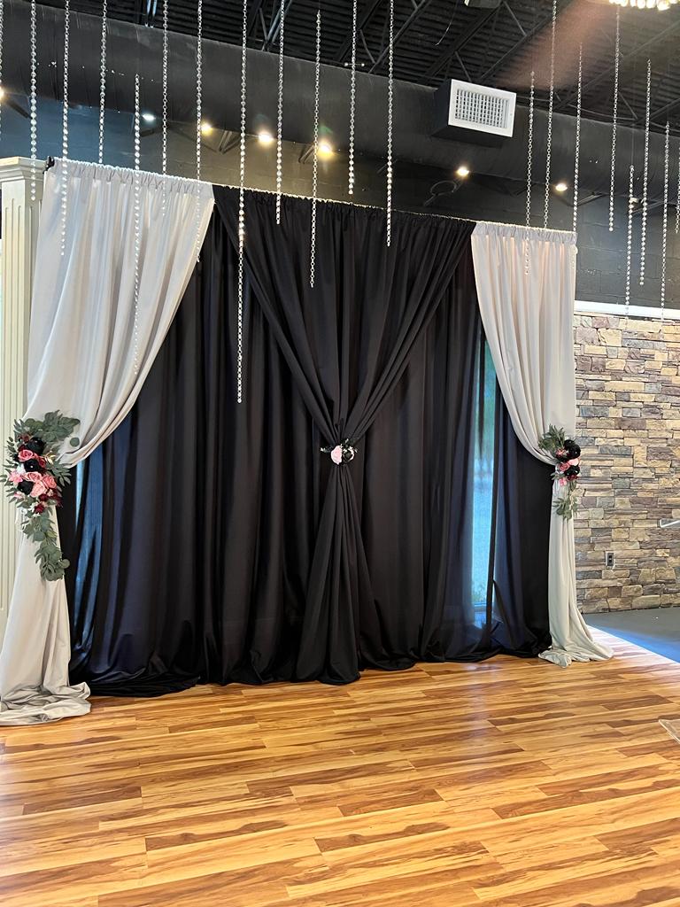 A room with two black and white curtains on the wall