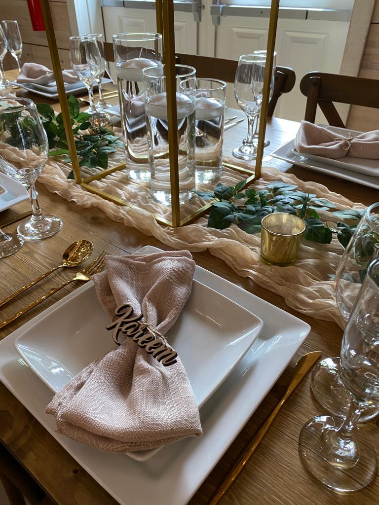 A table set with plates, napkins and glasses.