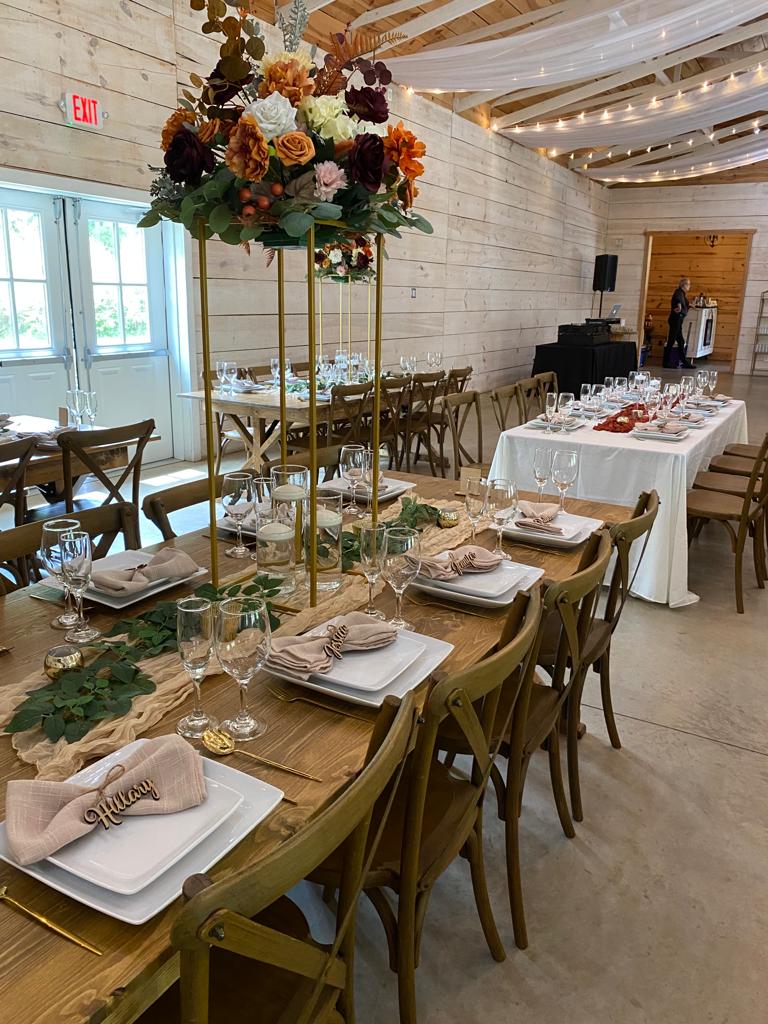A long table with many plates and flowers on it