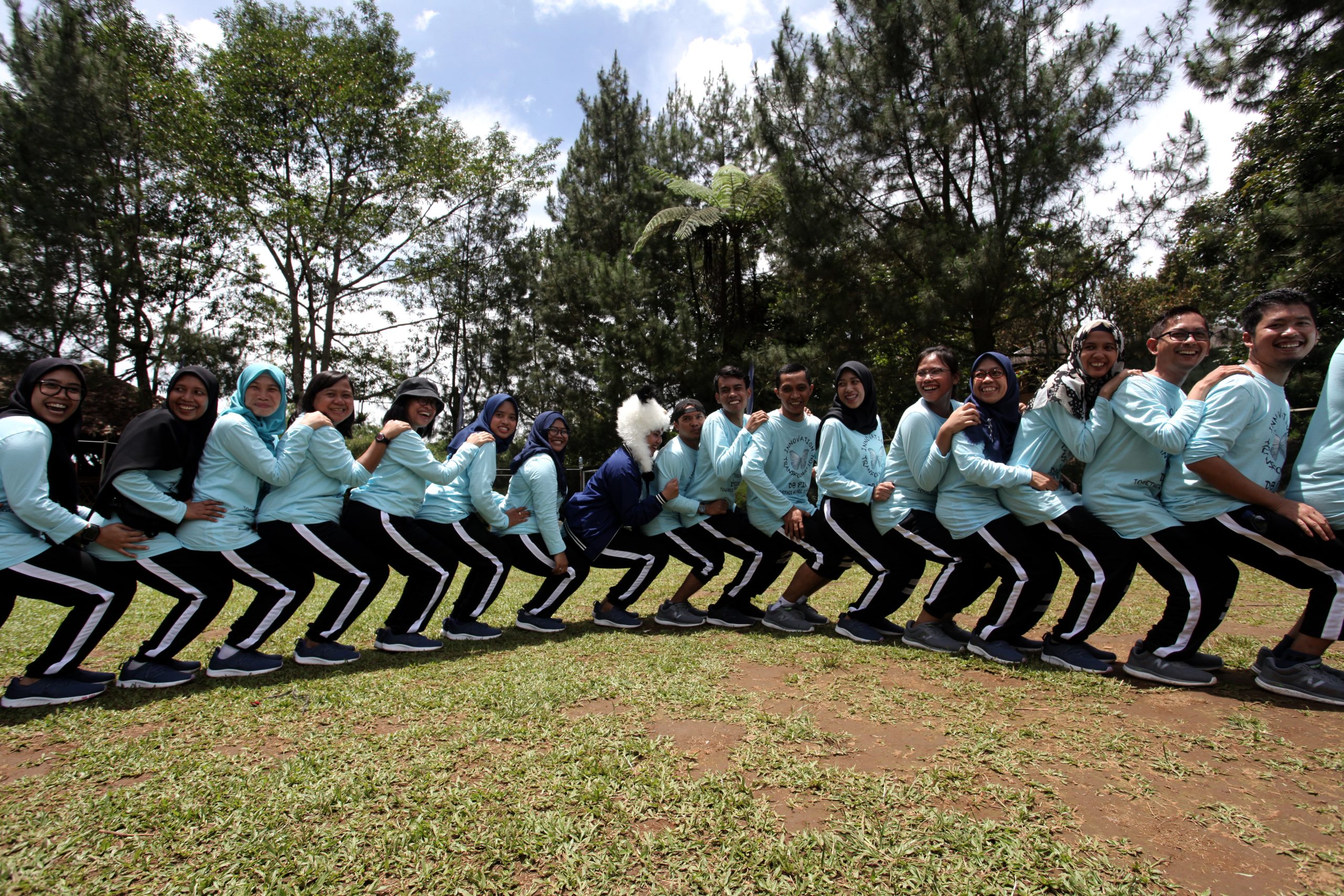 A group of people in blue jackets and black pants.