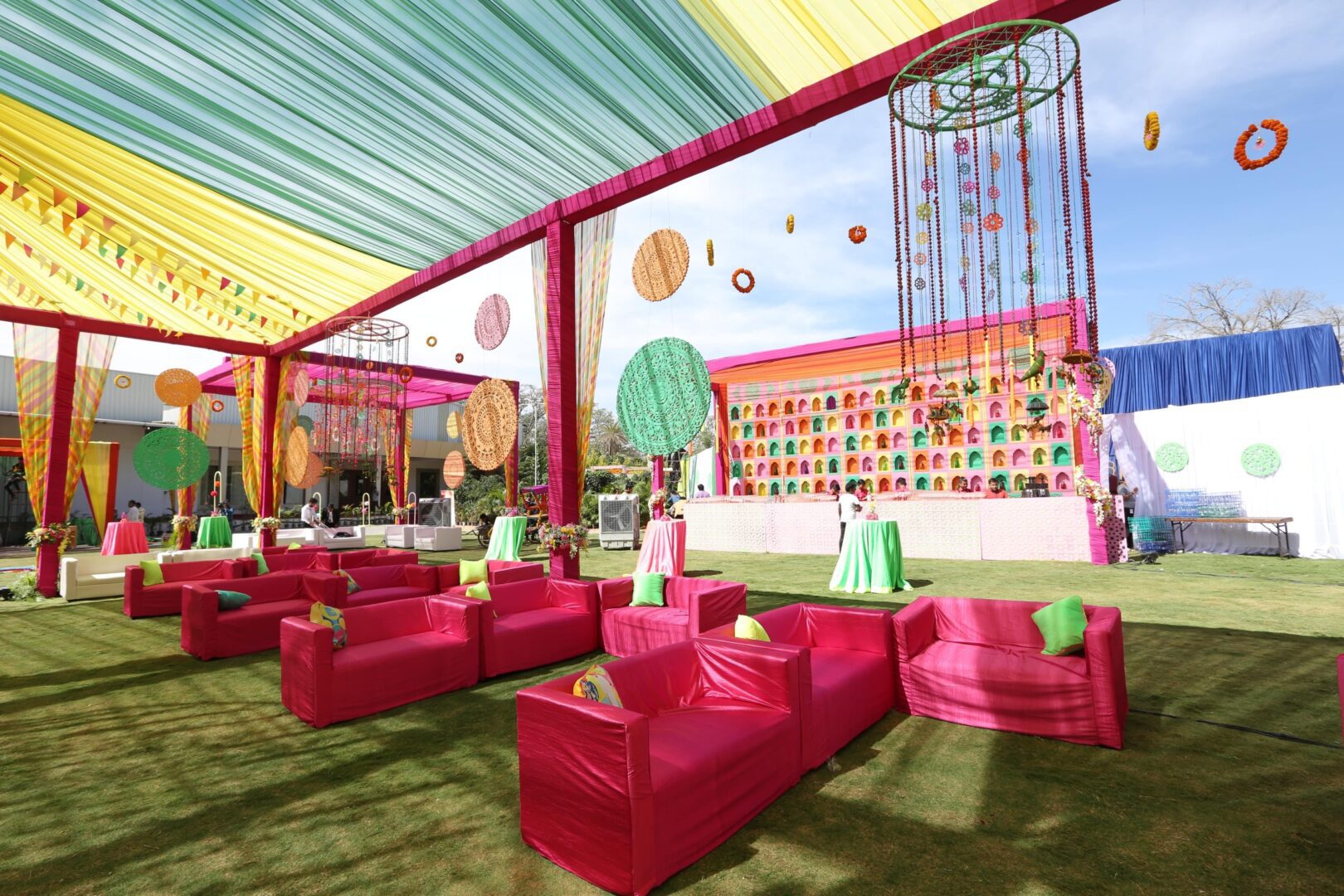 A colorful event with pink couches and green chairs