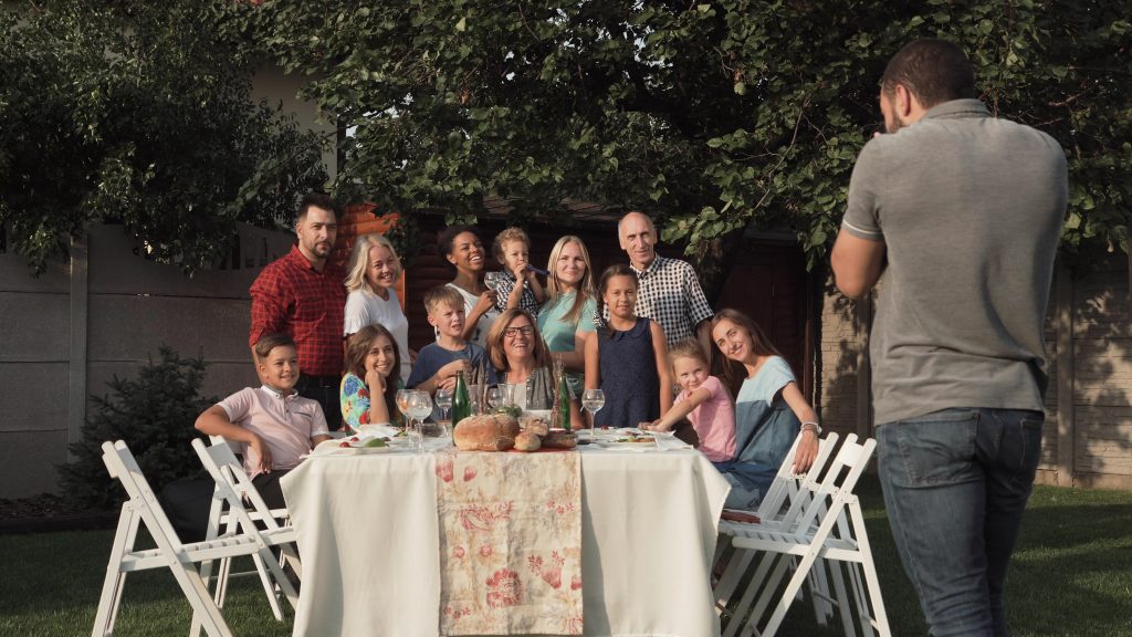 A group of people sitting at a table with food.