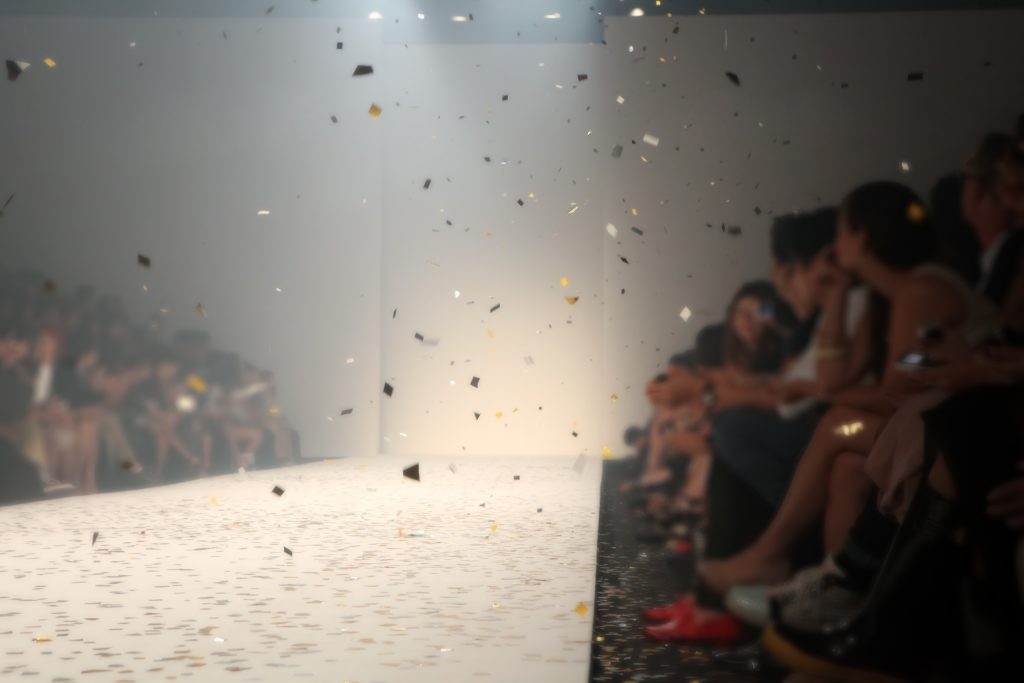 A group of people sitting on the runway