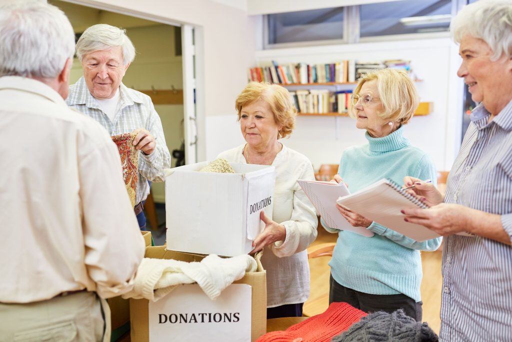 A group of people standing around some boxes