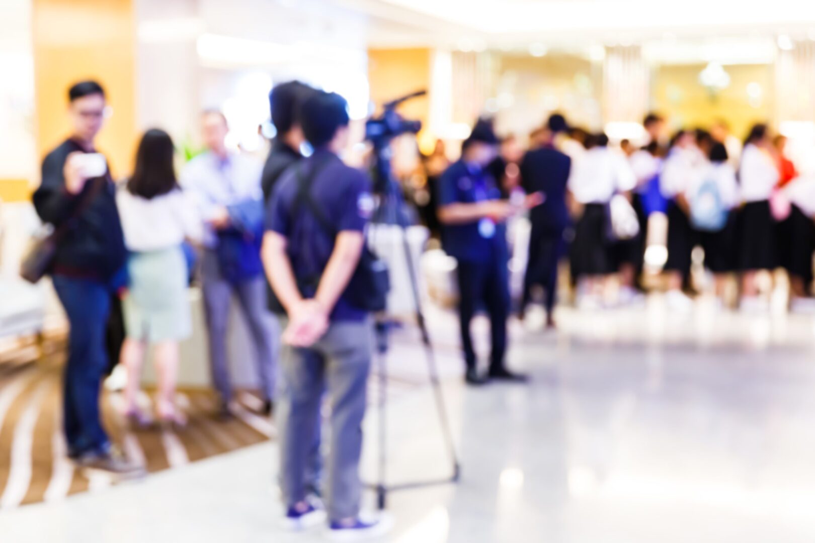 A group of people standing around in an area.