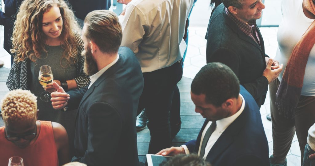 A group of people standing around each other.