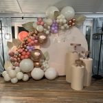 A room with balloons and flowers on the wall