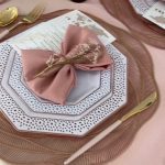 A table set with plates, napkins and silverware.