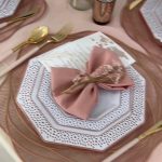 A table set with plates, napkins and silverware.