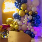 A table with flowers and balloons on it
