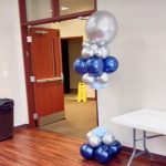 A tall balloon display in the shape of a giant ball.