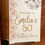 A sign that says welcome to emelia 's 5 0 th birthday.