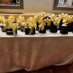 A table with many black and gold boxes on it
