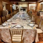A long table with plates and silverware on it